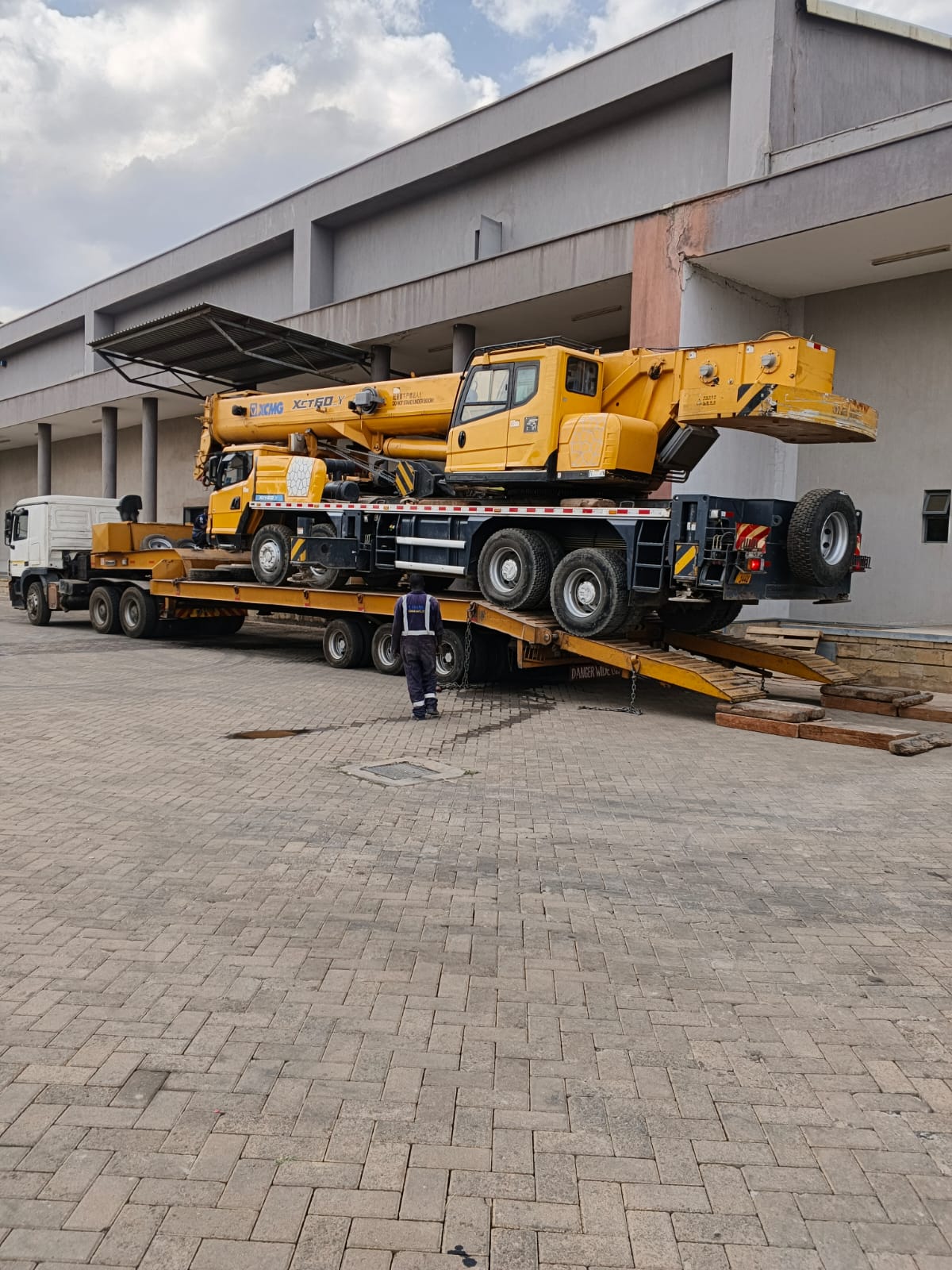 Crane being loaded onto a low loader for heavy transport operations